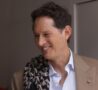 John Elkann in primo piano, sorridente e con sguardo di lato